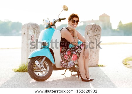 Vintage image of young attractive girl and old scooter