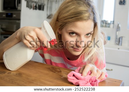 Concentrated woman cleaning the bar in kitchen