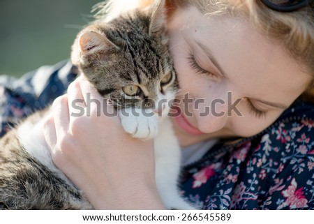 Blonde woman playing with her adorable cat