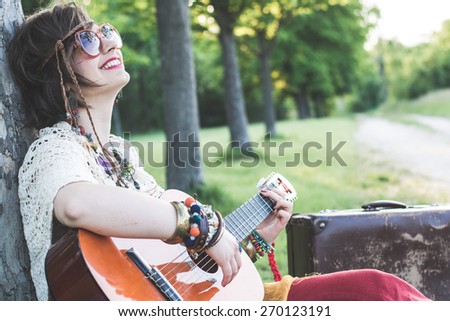 Hippie woman playing guitar