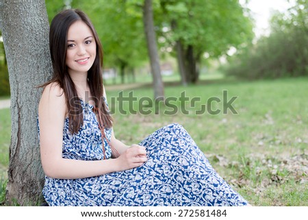 Summer girl portrait. Asian woman smiling happy on sunny summer day outside in park