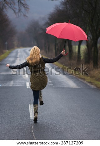 Rainy day woman holding red umbrella