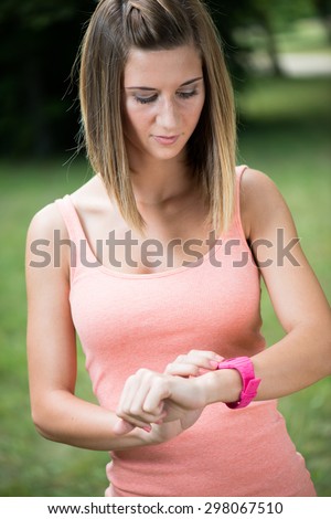 Healthy sport woman using smart watch to track fitness activity