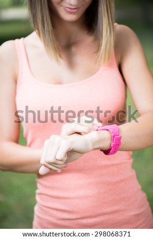 Healthy sport woman using smart watch to track fitness activity