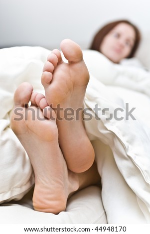 Woman\'s feet under the blanket