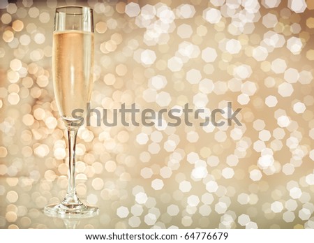 Glass of champagne against golden background