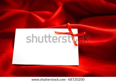 red gift tag tied with a bow of red satin ribbon