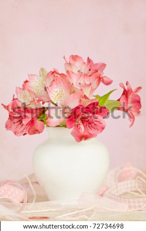 Bouquet of pink flowers in vase isolated on pink background