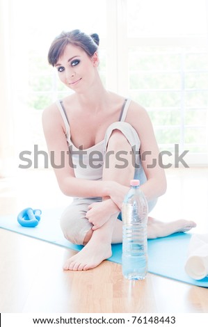 Beautiful sport woman doing power fitness exercise at home
