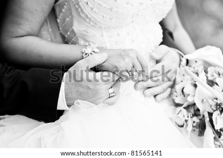 Bride and groom holding hands, black and white image