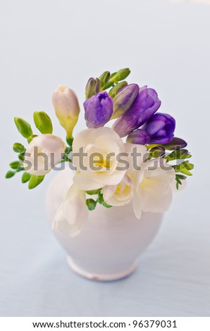 Bouquet of white and purple flowers in vase