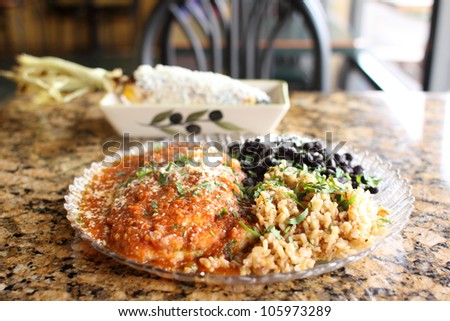 Chili Rellenos with rice and beans at a restaurant.