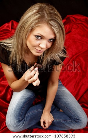 Young and attractive woman with chocolate candy..