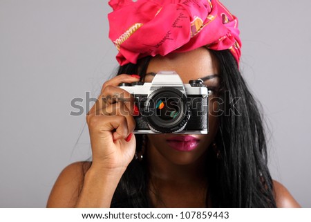 Sexy young woman with a retro film SLR camera.