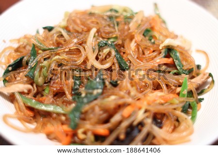 Korean dish known as Japchae made from sweet potato noodles, stir fried in sesame oil with various vegetables.