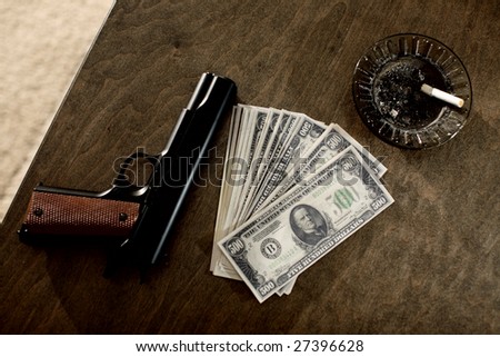 A gun on the table next to cash and ashtray.