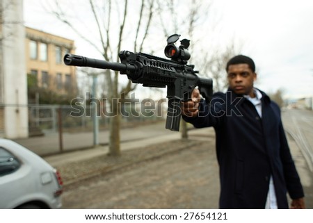 A stylish young man with an assault gun.