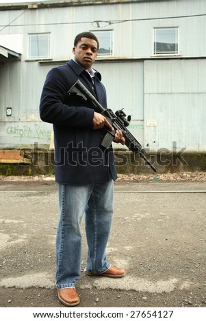 A stylish young man with an assault gun.