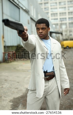 A stylish young man with a shotgun.