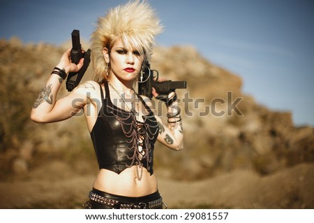 Young alternative woman with dual automatic pistols.