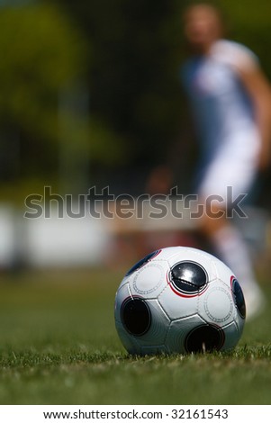 Soccer ball and player on the field.