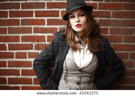 Portrait of a young and stylish woman wearing a fedora.