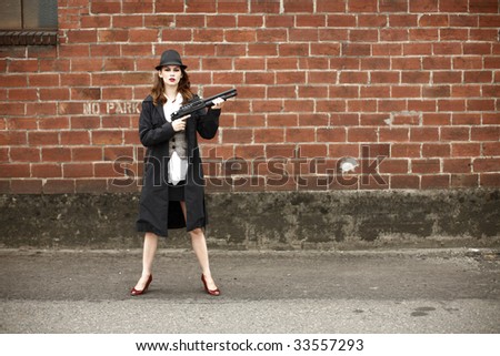 A young and stylish woman holding a shotgun.