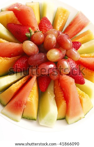 A plate of assorted freshly cut fruit.