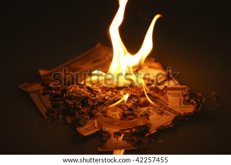 US hundred dollar bills on fire.