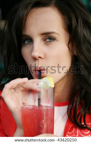 Beautiful woman sipping on a drink.