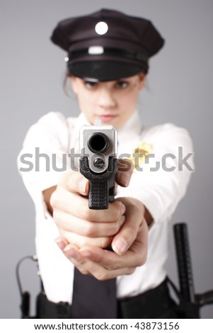 Female police officer aiming gun.
