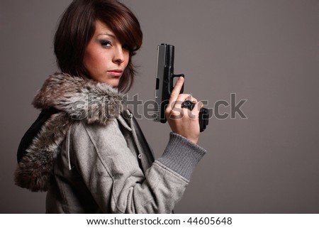 A young fashionable woman with a pistol.
