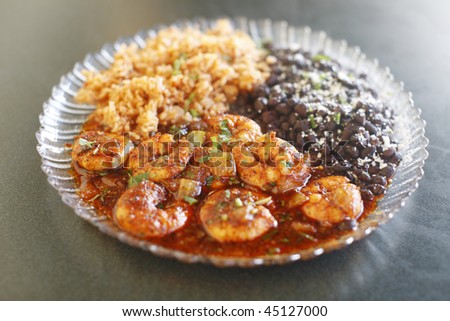 Mexican style shrimp dinner with rice and beans.