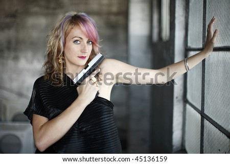 Woman in black with gun