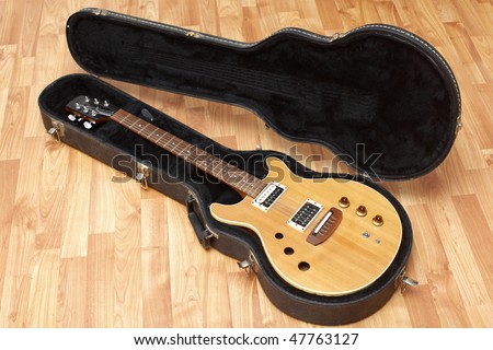 A vintage electric guitar in its case.
