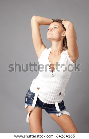 Young woman wearing denim shorts with suspenders.