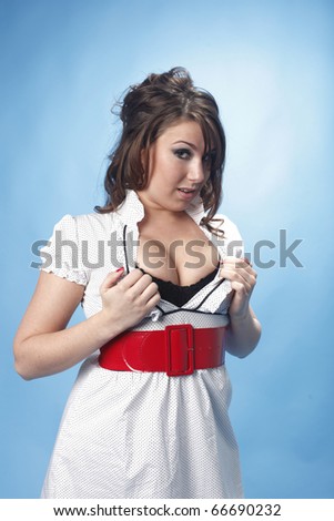 Young and sexy woman wearing a white dress with a red belt.