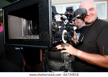 Man with digital cinema camera on movie set.