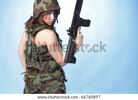 Sexy army woman with assault rifle.