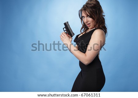 Sexy young woman with a pistol.