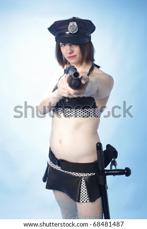 Sexy female police officer with a shotgun.