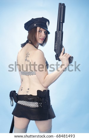 Sexy female police officer with a shotgun.