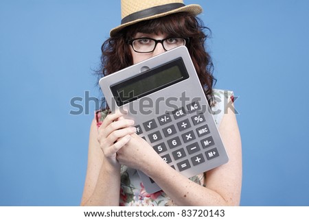 A cute woman with glasses holding a calculator.