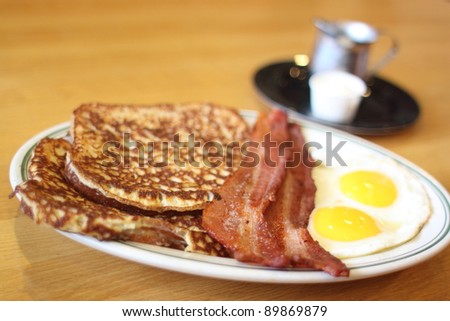 Delicious French toast with bacon and eggs for breakfast.