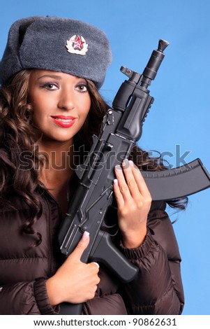 Beautiful young Russian woman holding an AK47 automatic rifle.