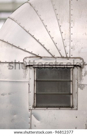 Window on an old auto camper trailer.