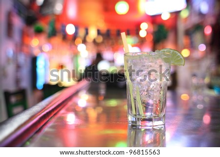 Gin and tonic cocktail at a bar.
