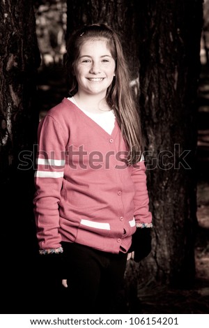 Little girl standing outside in a park