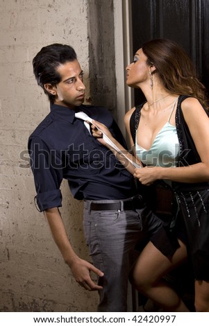 Woman seducing a man in a back alley