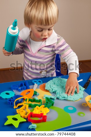 Little girl playing with play dough
